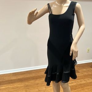 Sexy black mini dress with lace on one side & flirty frills at the bottom.